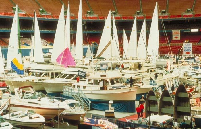 Sailboats and yachts on display at a boat show on the Kingdome floor